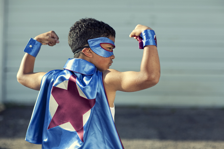Young Dark Skinned Superhero Flexing His Muscles