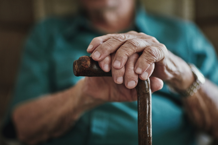Shot Of An Unrecognizable Man Leaning On His Walking Stick