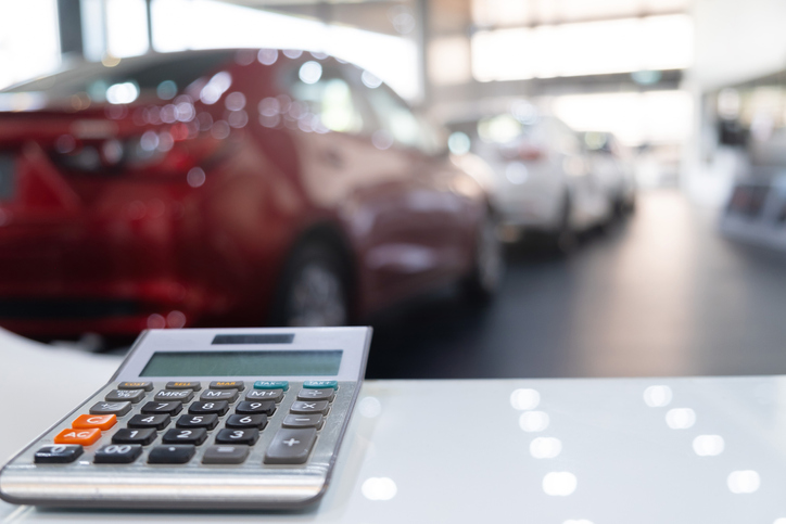 Calculator For Business Finance On Car Showroom Blurred Bokeh Background