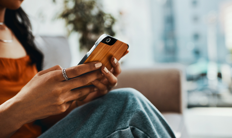 Cropped Shot Of A Woman Using A Smartphone