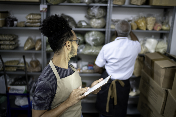 Person Holding Tablet Looking Over Shoulder