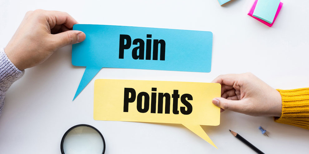 Customer Pain Points Written On Blue And Yellow Paper
