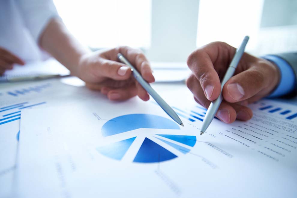 Hands Of Business People Pointing At Market Research_
