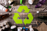 Sustainability Green Recycling Sign With Bottles Around It