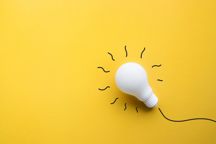 White Lightbulb On Pastel Color Background