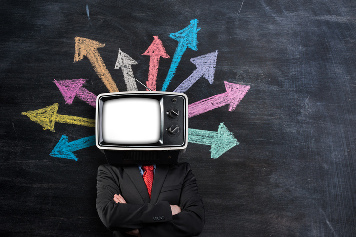 Businessman With Tv Head In Front Of Blackboard
