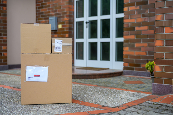 Cardboard Packages On The Floor At The Doorstep Of A House