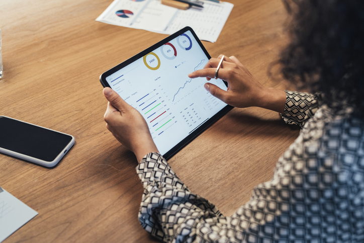 Business Person Looking At Data On Tablet