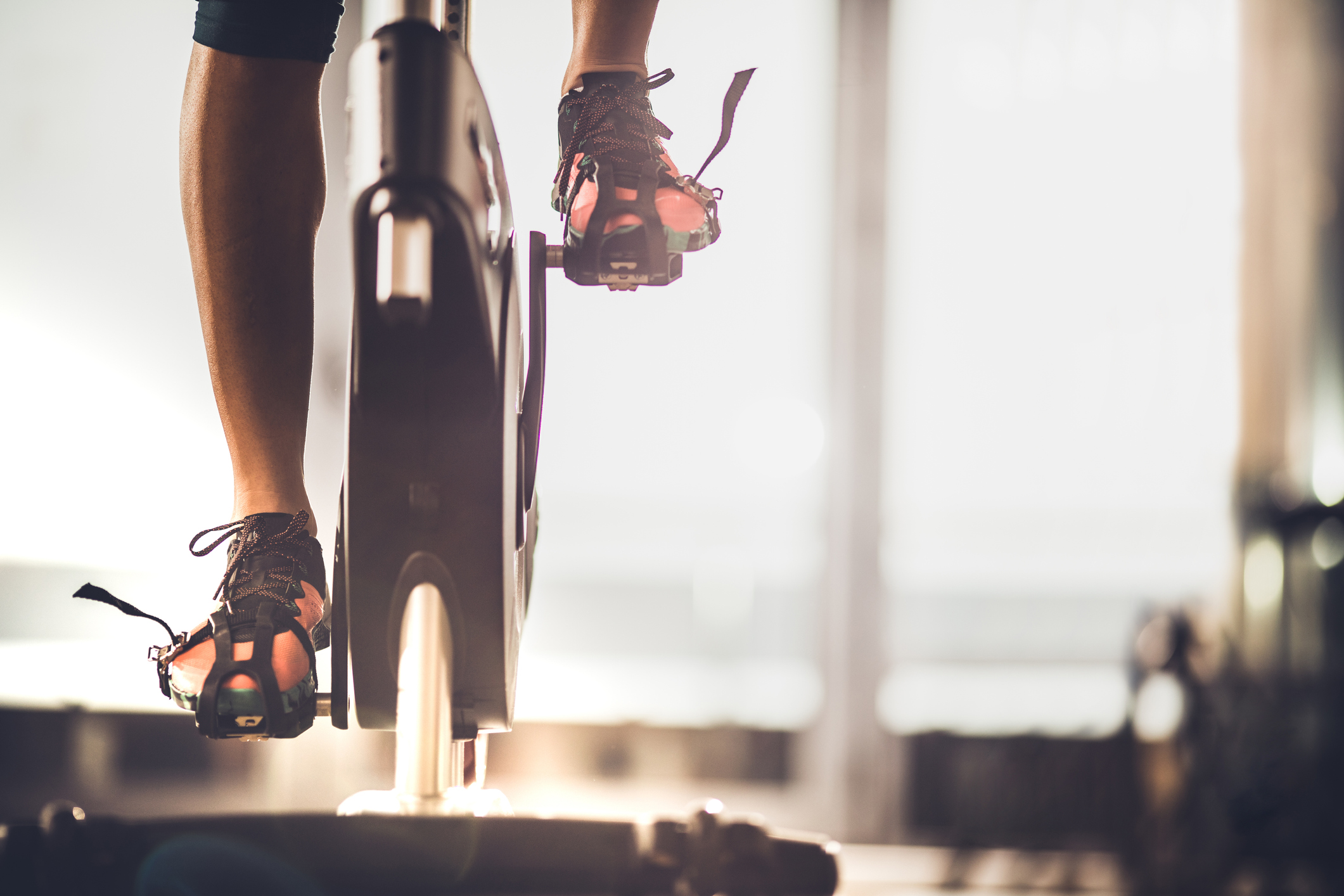 Female Athlete Exercising On Exercise Bike In A Gym