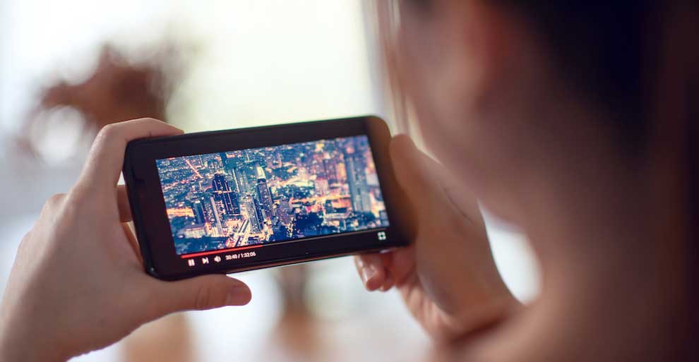 Person Holding Cell Phone Playing Video