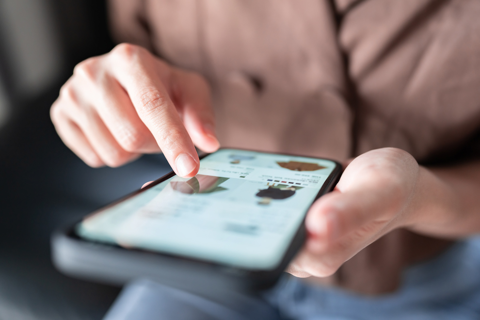 Close Up Finger Scrolling Through Mobile Shopping Website