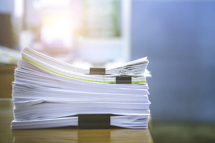 Stacks Of Paper Files On Desk